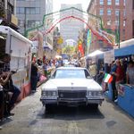 A car rides up Mulberry Street during the procession.
